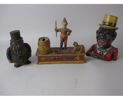 Three cast metal Money Boxes, one in form of a pipe smoking Gerald Kruger, a Trick Dog and another, a black man with yellow t