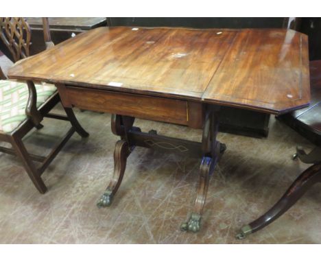 A Regency mahogany Sofa Table with brass inlay, drop leaves fitted frieze drawer on lyre cheval supports