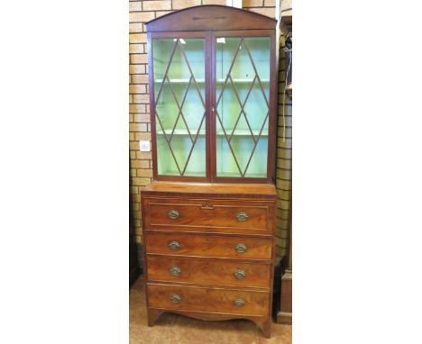 A Regency mahogany Secretaire Bookcase, the domed pediment above diamond glazed doors over a base of four long drawers includ