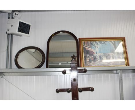 A framed continental print; and an arch framed mirror; and an oval bevel edged wall mirror 