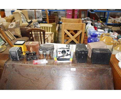 A quantity of box cameras, Polaroid camera, binoculars etc.