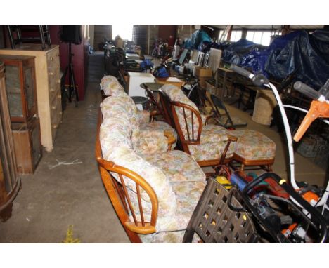 An Ercol style three piece cottage suite to include a rocking armchair and matching foot stool 