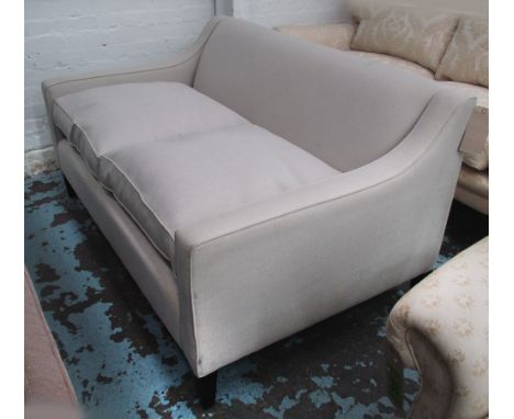 SOFA, of contemporary design in an ivory upholstery with ebonised feet, 78cm x 148cm x 92cm.