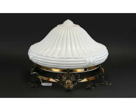Moulded Opaque White Glass Ceiling Lamp, with a copper finished mask mount, suspended on chains.