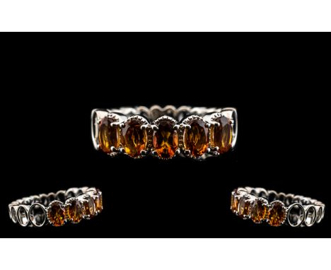 Madeira Citrine Band Ring, five oval cut, deep, warm Madeira citrines totalling 2cts, held within millgrain frames, with the 