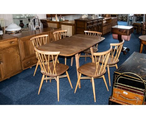 An Ercol Drop Leaf Dining Table, of typical form, together with six dining chairs.  Height 28" x 54" x 29".