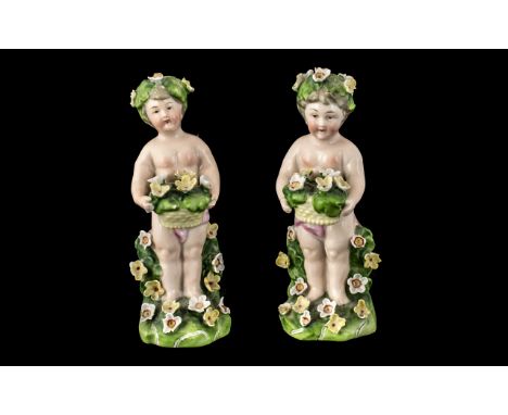 Pair of Antique Dresden Type Figures of Small Garlanded Cherubs. Height 5 Inches. A/F.