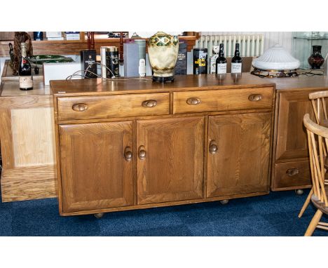 Ercol Dresser comprising two frieze drawers above three cupboard spaces; 31 inches (app.77.5cms) high x 54 inches (app.135cms