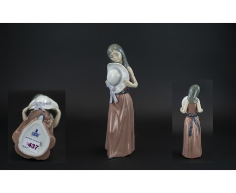 Lladro Hand Painted Porcelain Figure 'Bashful', model no.5007, issued 1978 - 1997, 9.25 inches (23.2cms) high; first quality 