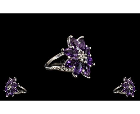 Deep Purple Amethyst Cluster Ring, eight marquise cut amethysts, totalling 4cts, form an elongated, stylised flower cluster a