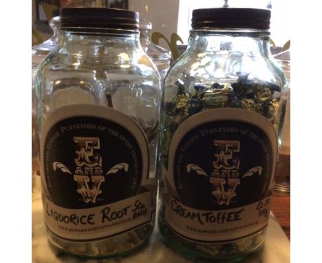 Two vintage original Horlick Jars. Embossed glass with tin lids. 11 inches tall. (Sweets not included)!please study pictures.