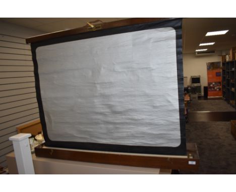 A Houghton Butcher folding projector screen in an oak case