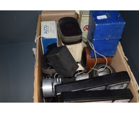 A box of various lenses and camera parts