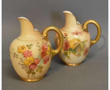 A Pair of Royal Worcester Blush Ivory Jug Vases each hand painted with summer flowers and highlighted with gilt and numbered 