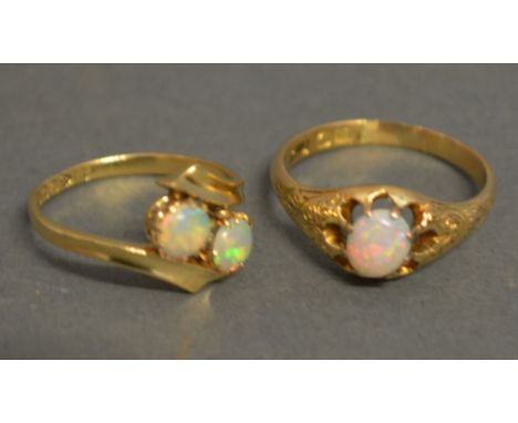 An 18ct Yellow Gold Opal Ring set with two opals within a crossover setting together with another similar 18ct yellow gold an