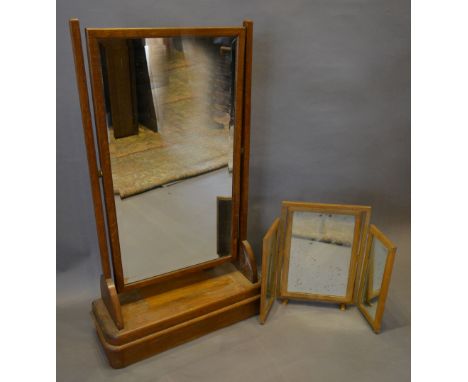 An Art Deco Oak Swing Frame Dressing Mirror with moulded base together with a triple folding dressing table mirror