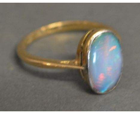 An 18ct Yellow Gold and Opal Ring set with large cabochon oval opal within a pierced setting