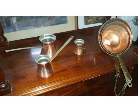 A Collection of Copper & Brass Kitchenalia  to include a 19th century strainer and ladle, three graduated straining pans, thr