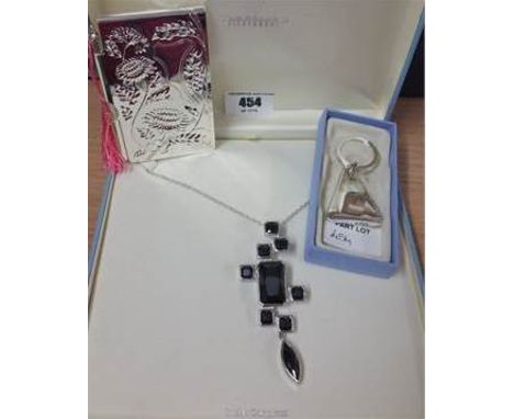 Newbridge Silverware: An Embossed Notebook & Pencil with Pink Tassel, Key Ring & Silver Tone Necklace with Black Stones (3).