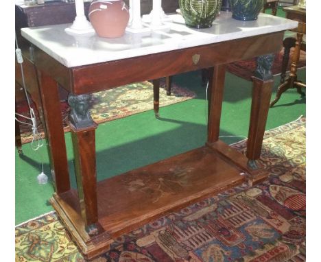 A French Empire Mahogany Marble Topped Console Table with frieze drawer, Egyptian front figural supports, the lower tier inla