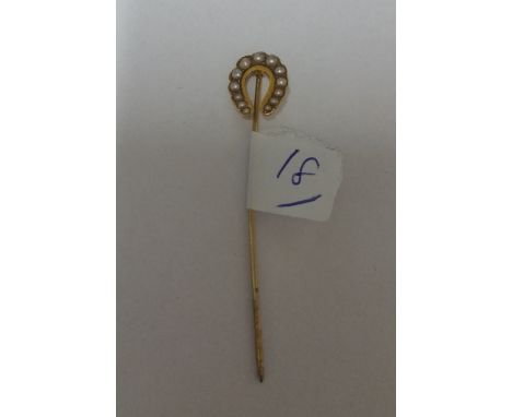 An Antique Gold Horseshoe and Pearl Stick Pin.