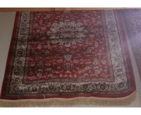 A Red Ground Kashmir Rug with Shahbaz Medallion Design.
