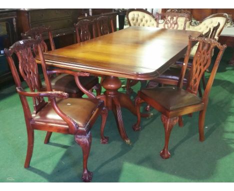 A Good Two Pillar Mahogany Dining Table and Eight Chippendale Style Chairs; with brown leather seats.