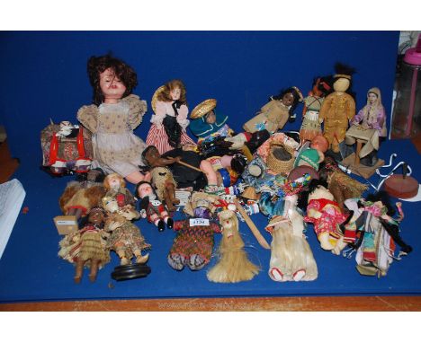 A box of vintage international dolls including interesting examples with bead work, feathers etc.