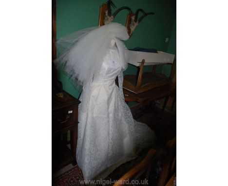 A Vintage lace long sleeve Wedding Dress with train and netted underskirt, back zip opening, no labels, possibly a size small