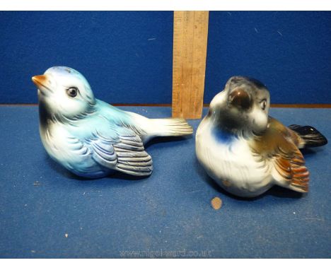 A pair of Goebel birds in blue and brown.