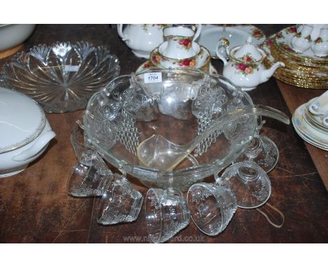 A glass Punch Bowl having 12 punch cups and a plastic ladle, bowl 12 1/2" diameter.