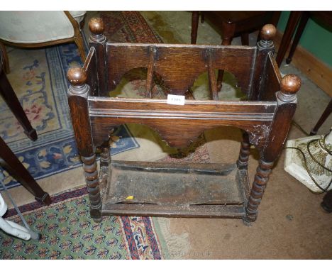 A rectangular Oak umbrella/stick Stand having canted bobbin turned legs, three recesses and complete with drip tray, 26 1/2''