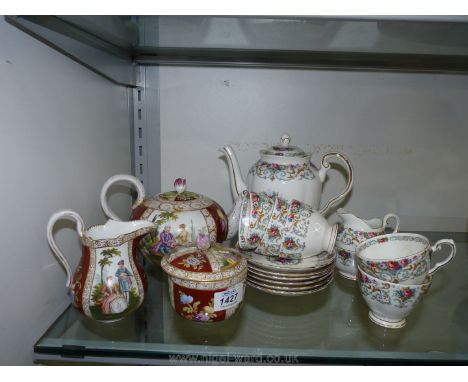 A Limoges teapot, milk jug and lidded sugar bowl having rose finials together with a Tuscan part floral coffee set in Orleans
