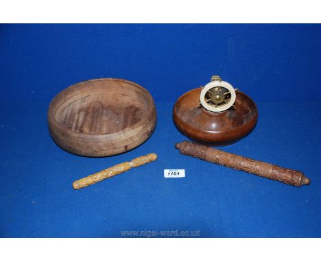 A wooden and brass ship's wheel, nut cracker, a wooden bowl and carved needle cases.