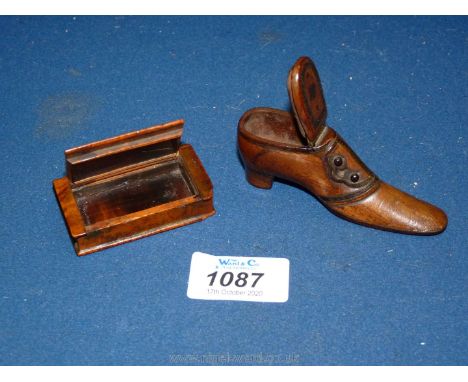 A treen walnut shoe shaped snuff box with opening lid and pique decoration to the sole and upper, together with a book shaped