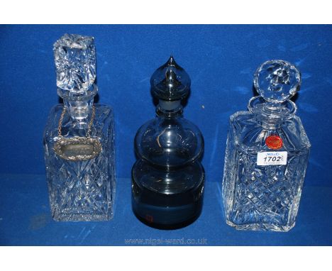 Three decanters including a Webb square decanter, a Dartington smoky glass decanter, (bottom of stopper damaged) and another 