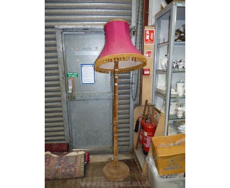 A most unusual Standard Lamp bound with brown velvet and complete with tasselled pink shade
