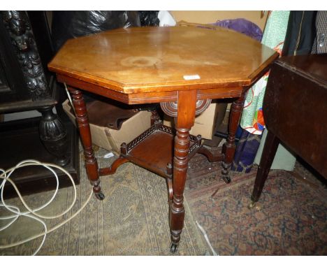 An Edwardian Mahogany octagonal occasional Table standing on turned legs and with a lower galleried shelf, 29 1/4'' diameter 