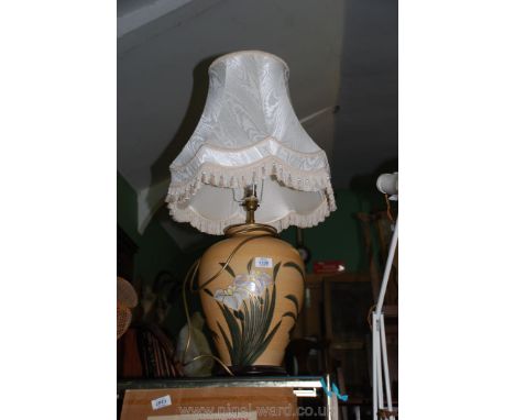 A large crackle glazed pale orange Table Lamp with flower and butterfly decoration, cream six shade, the base being 18 1/2'' 