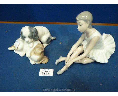 A German Nao figure of a ballet dancer and a pair of dogs sleeping.