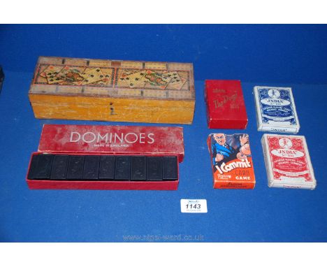 A wooden Cribbage board decorated with playing cards, Dominoes set, two sets of playing cards, Community card game and a Wadd