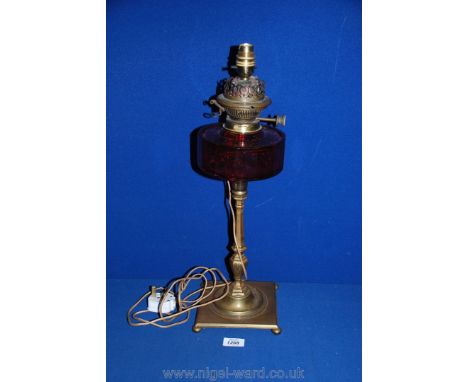 A Brass Oil Lamp with cranberry glass oil reservoir, converted to electric, 20 1/2'' tall