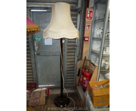 A turned dark-wood Standard Lamp and fringed shade