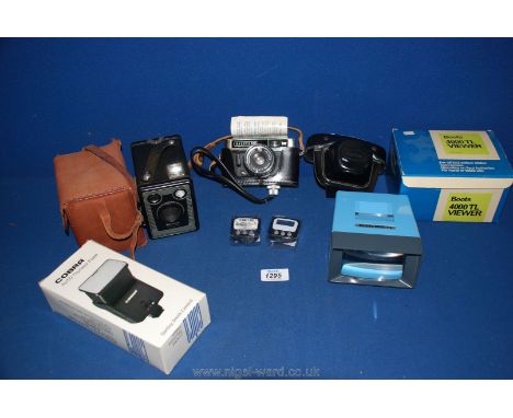 A Halina 500 35mm Camera with instructions and ever ready case, a Kodak Brownie Six-20 Camera model C with original case, a C