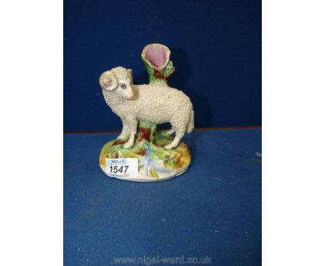 A small Staffordshire spill Vase in form of sheep leaning on a trunk (slight chip to rim).