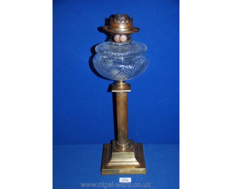 A Brass Oil Lamp with clear cut glass oil reservoir standing on reeded column,  20'' tall