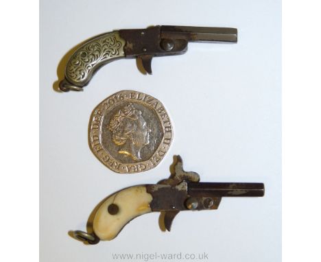 Two very uncommon and highly collectable antique miniature duelling pistols with movable parts including one with ivory colou