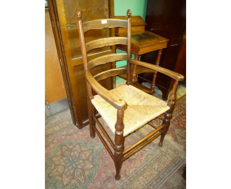 A good Oak ladder back open armed Elbow Chair having turned legs, stretchers and back supports terminating in appropriate aco