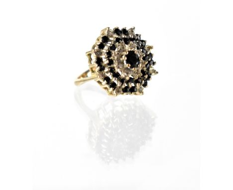 A 9ct gold diamond and black stone cluster ring, the cluster set over four tiers, size L/M, approx 6.1g. CONDITION REPORT Sta