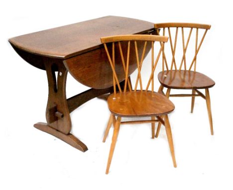 An Ercol c1970s seven-piece elm and beech dining suite comprising drop-leaf dining table with slab ends, length when extended